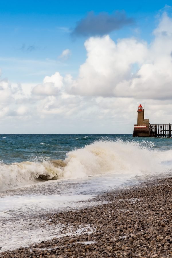 Lighthouses and guidance at the entrance of the Port of Fecamp, Normandy, France, Europe on the coast of Normandy in the English Channel in Autumn. Seascape with waves.